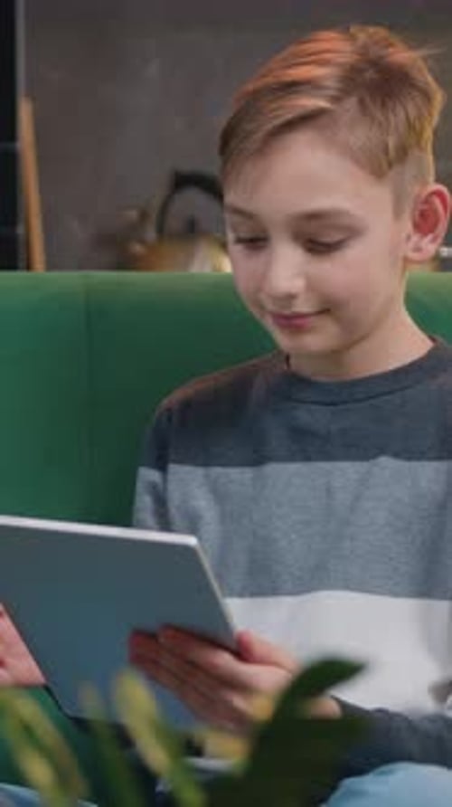 Little Boy Using Tablet on Sofa at Home Spending Quality Time at Home Social Network Playing Online