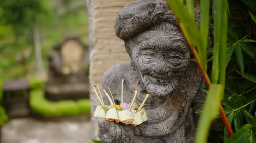 Old Woman Carved From Stone with an Offering of Flowers on Her Guardian Statue