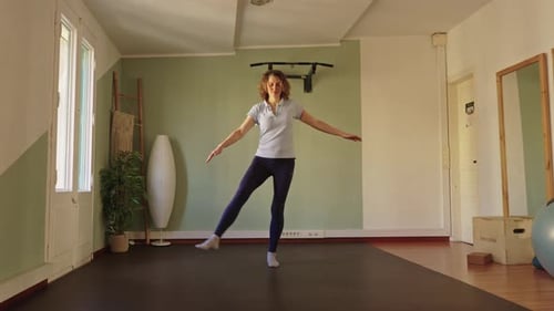 Woman Practicing Leg Raises for Health and Fitness