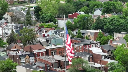 American Flag Waving Over Residential Neighborhood