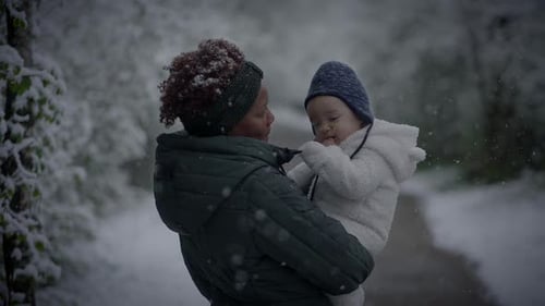 Mother and Child Walking on a Snowcovered Path Sharing Love in a Serene Winter Setting