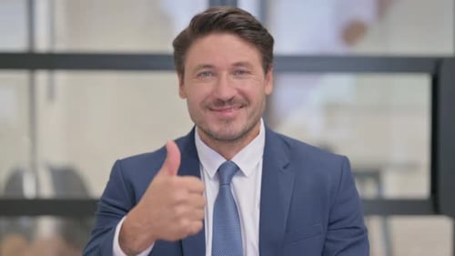 Man in Suit Gives Thumbs Up