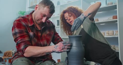 Two People Making Pottery in Studio