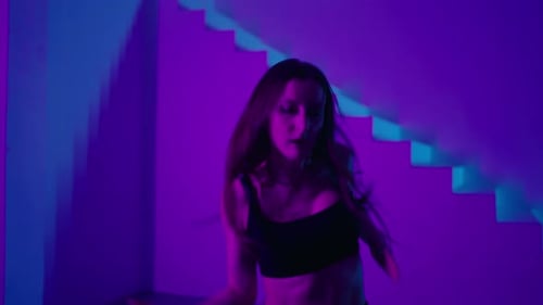 Female HipHop Dancer Moving Emotionally In Studio With Neon Lights FullLength Portrait