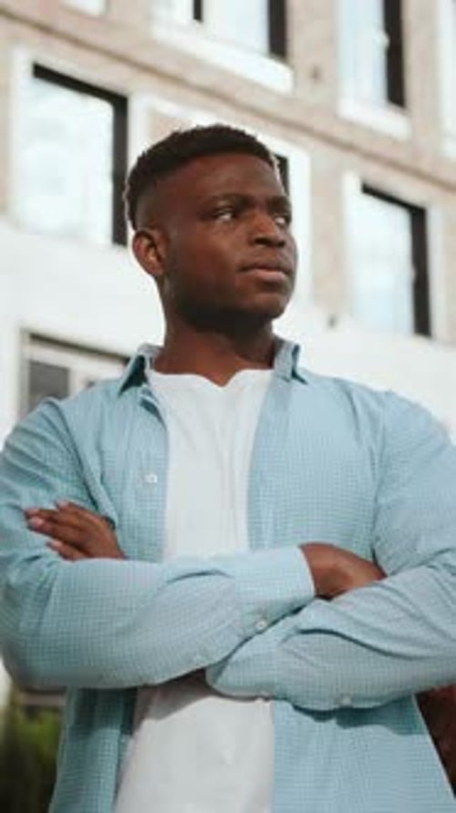 Serious African American Man Stands Near Office Building
