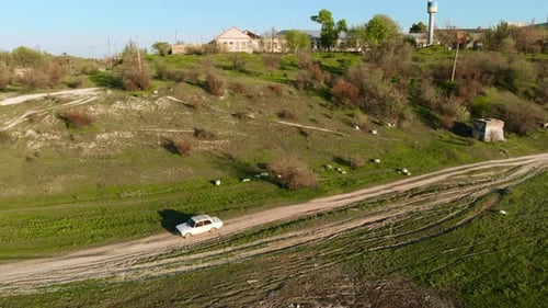 Old White Vintage Car Rides on Country Road