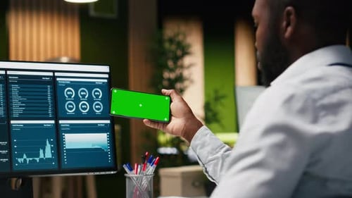 Green Screen Mockup Screen on Mobile Phone Held By a General Manager