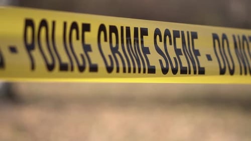 Police Crime Scene Do Not Enter Warning, Yellow Tape Ribbon With Black Letters and Bokeh, Close Up