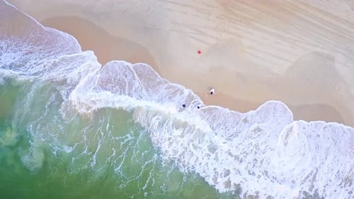 Aerial Top view of a transparent blue sea with beautiful waves at sunny day in summer. air of ocean