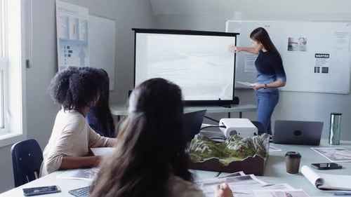 Environmental scientists collaborate on topographic maps at office meeting