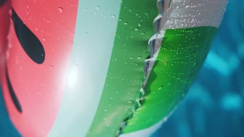 Red inflatable ring in the water of a swimming pool on a sunny day. Summer holiday concept. Inflatab