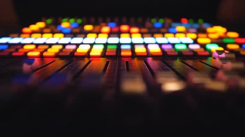Low View of Dj Remote or Soundboard with Moving Buttons and Brightly Glow Keys Working Process on