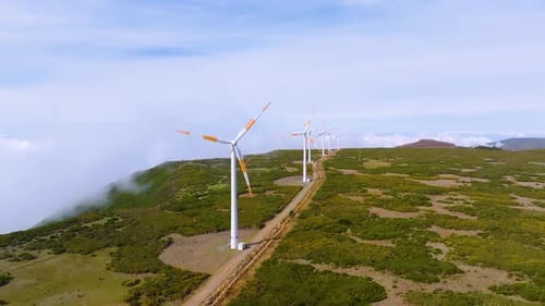 Wind Turbines Turning on Rural Green Hillside