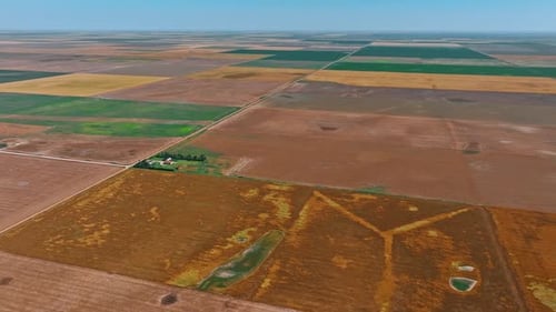 Lonely green farm in the vast deserted lands.