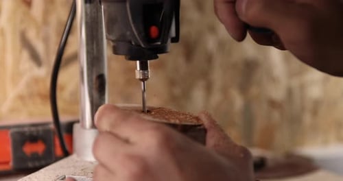 Carpenter Working on the Drill Machine in His Workshop