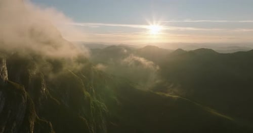 Dramatic Mountain Valley Sunrise with Rolling Clouds - Alpine Landscape Aerial View