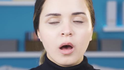 Close-up of young woman looking around and looking at camera in amazement.