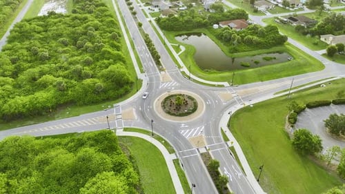 Aerial View of Road Roundabout Intersection with Moving Cars Traffic