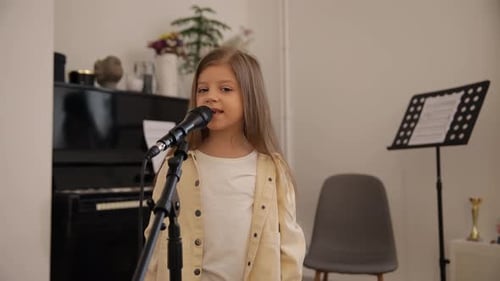 Young Girl Singing Into Microphone In Home Setting