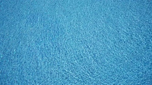 Closeup View of the Rippling Water of a Pool Creating a Mesmerizing Tranquil Blue Pattern