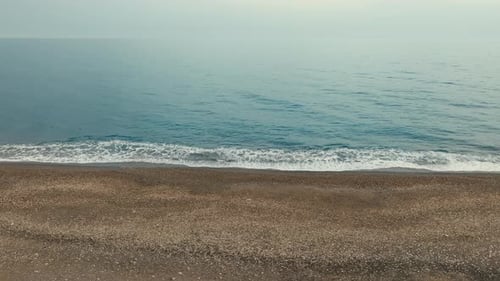 Calm Ocean Waves on Sandy Beach