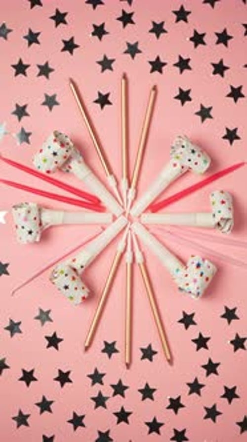 Top view accessories for a party or birthday on a pink background, spinning in a circle