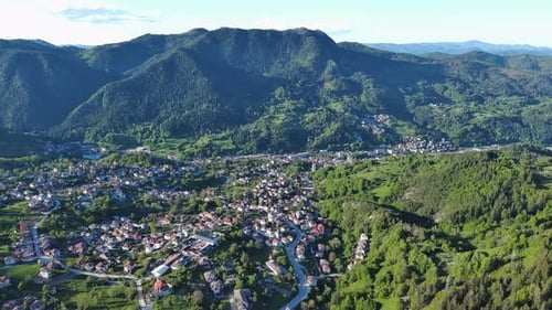 View From Rock to Town of Smolyan with Meadows for Cattle Walking and Houses Between Mountain Range