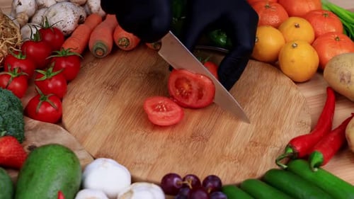 Tomato Sliced on Cutting Board Surrounded by Vegetables