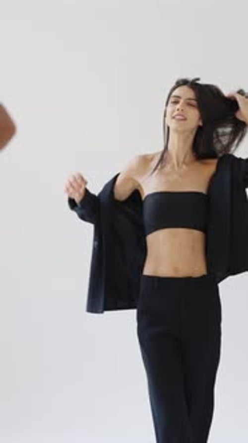 Brunette Model Posing in Fashionable Outfit in Studio