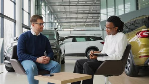 Customer Signing Car Purchase Agreement at Dealership