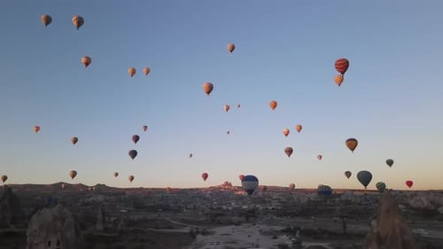 Hot Air Balloons Floating Over Rural Landscape at Sunrise