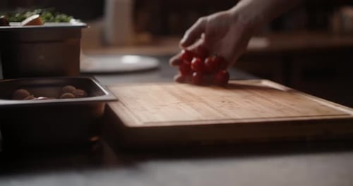 Chef Throws Cherry Tomatoes to the Cutting Board in Slow Motion