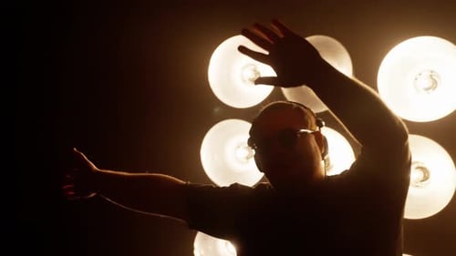 Silhouette Dancing in Front of Glowing Lights