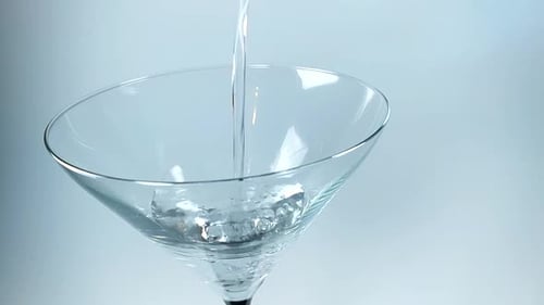 Clear Liquid Being Poured Into Martini Glass