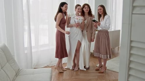 Bridesmaids Gathering Around Bride in Glowing Calm Moment before Wedding
