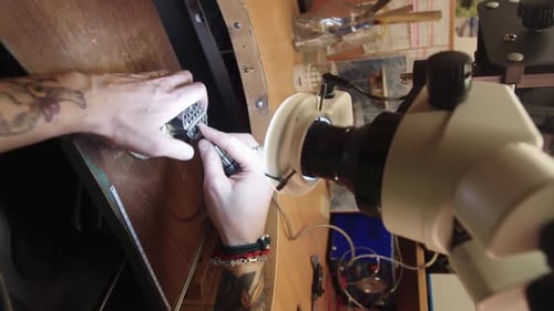 Adult Crafting Jewelry at Wooden Workbench Close Up