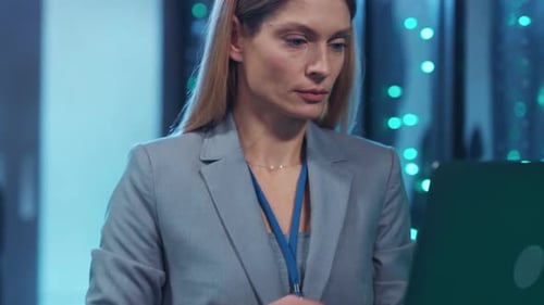 Business Woman Working on Laptop in Data Center