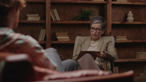 Adult Listens to Young Adult in Therapy Session