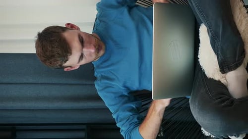 Man Using Laptop in Home Environment