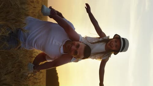 Father and Daughter Piggyback in Wheat Field at Sunset
