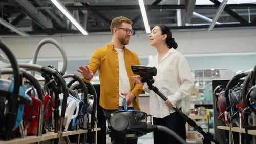 Couple Shopping for Vacuum Cleaner in Appliance Store
