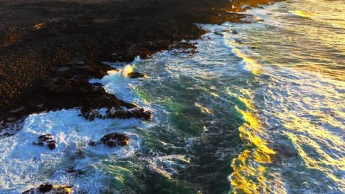 Coast of the Atlantic Ocean in Windy Weather Large Waves Crashing on Sharp Black Basalt Rocks