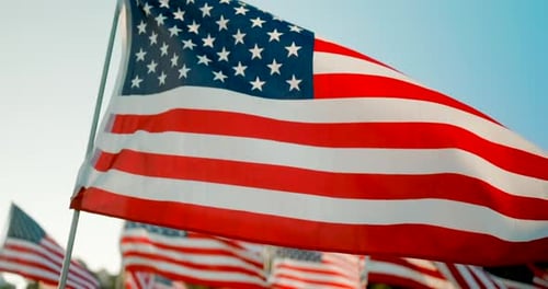American Flags Waving Proudly Against Blue Sky