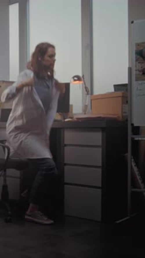 Female Scientist Takes Off Lab Coat Turns Off Personal Computer and Leaves