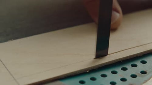 Saw Cutting Through Wood Piece in a Workshop