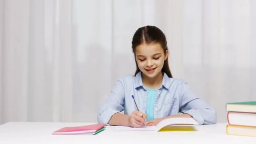 Education, People, Children And Learning Concept - Girl Hand Writing Math Task To Notepad At School