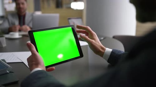 Coworker Man Researching Tablet Chroma Key Browsing Web Network On Business Conference Table. Unk...