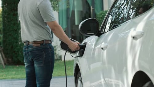 Progressive Man Unplugs the Electric Vehicle's Charger at His Residence