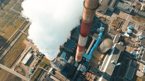 Smoke rises from tall chimneys of a coal power plant