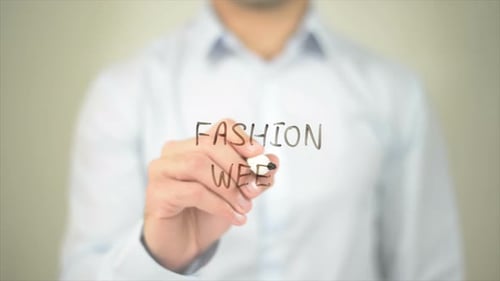Hand Writes Fashion Week on Clear Screen